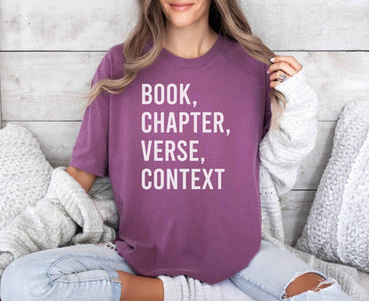 A comfort colors® shirt with the saying "book chapter verse context"