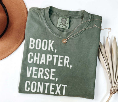 A comfort colors® shirt with the saying "book chapter verse context"