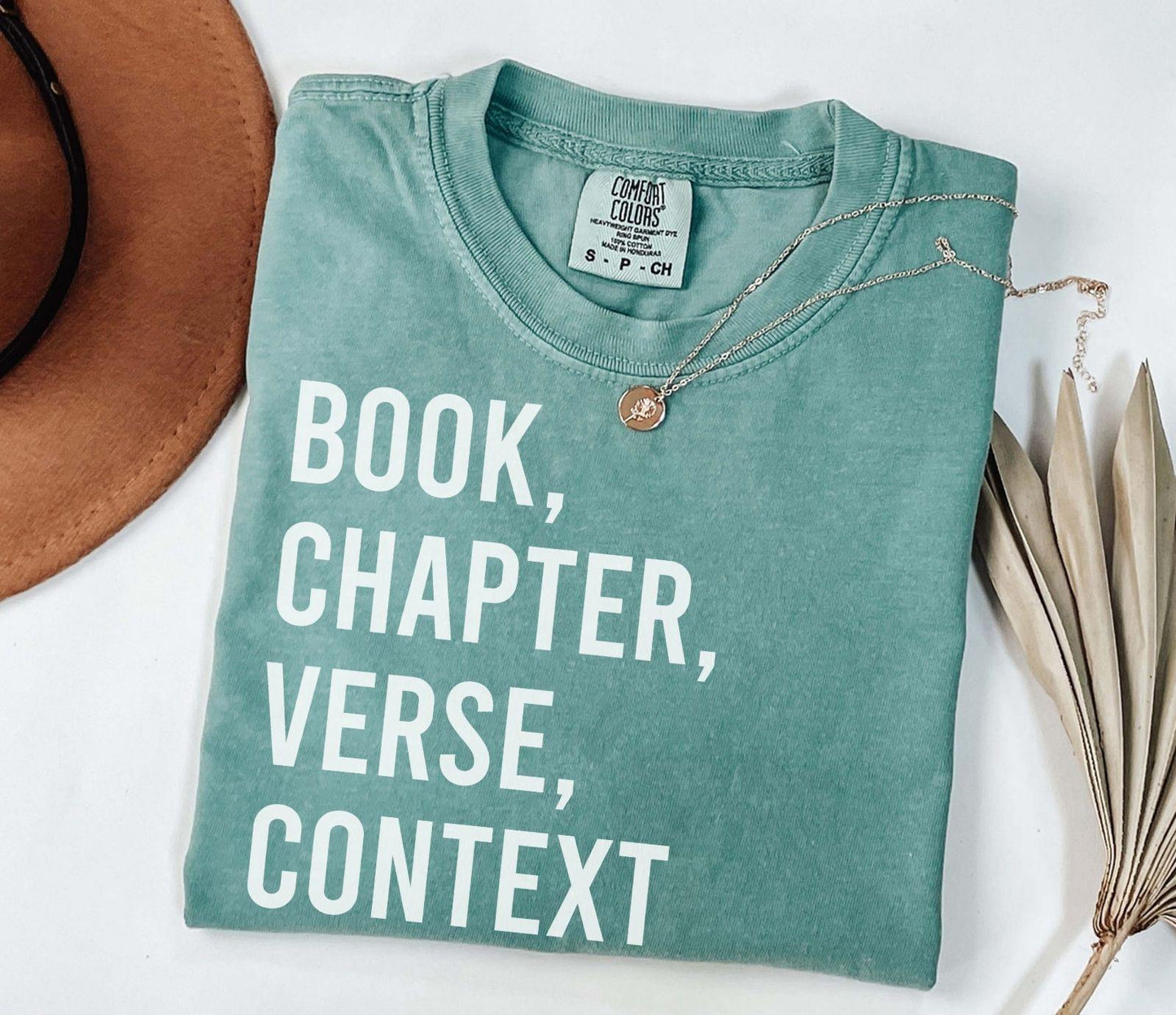 A comfort colors® shirt with the saying "book chapter verse context"