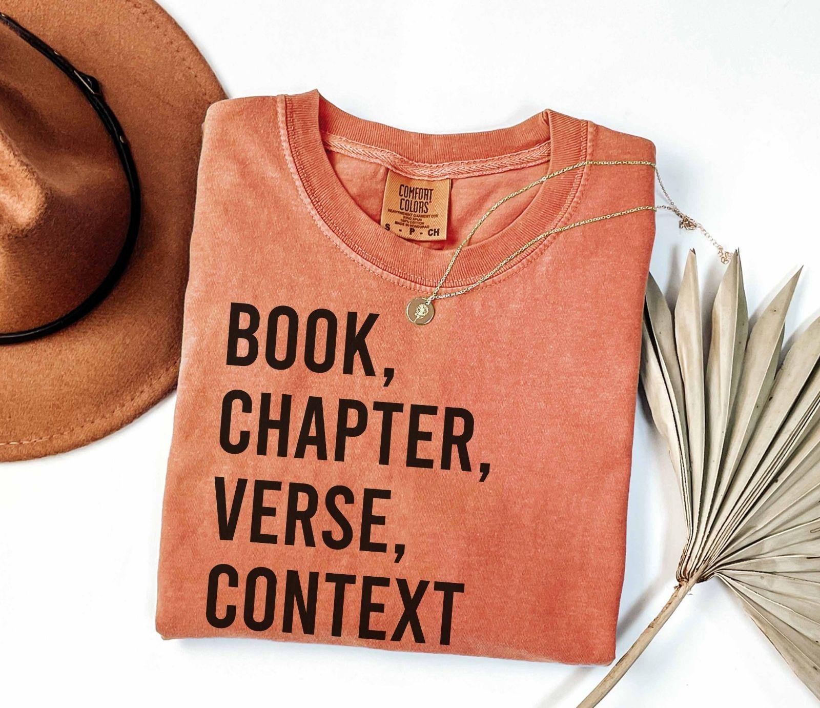 A comfort colors® shirt with the saying "book chapter verse context"