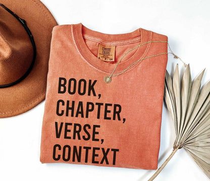 A comfort colors® shirt with the saying "book chapter verse context"