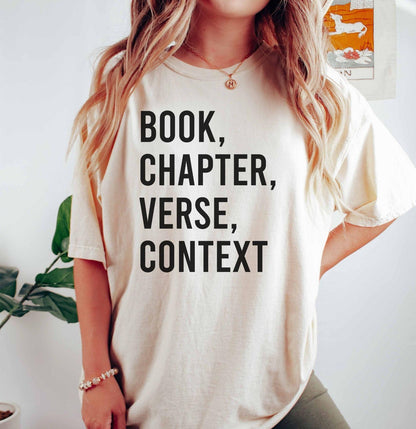 A comfort colors® shirt with the saying "book chapter verse context"
