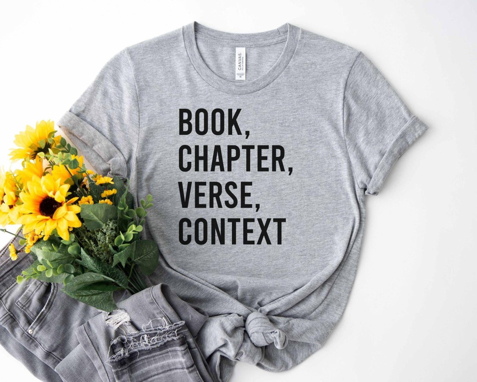 A bella canvas 3001 shirt with the saying "book chapter verse context"
