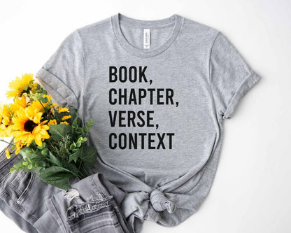 A bella canvas 3001 shirt with the saying "book chapter verse context"