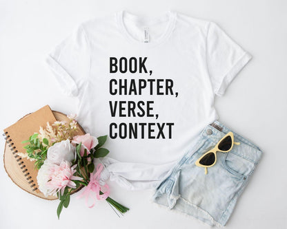 A bella canvas 3001 shirt with the saying "book chapter verse context"