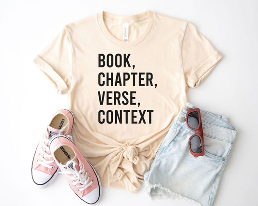 A bella canvas 3001 shirt with the saying "book chapter verse context"