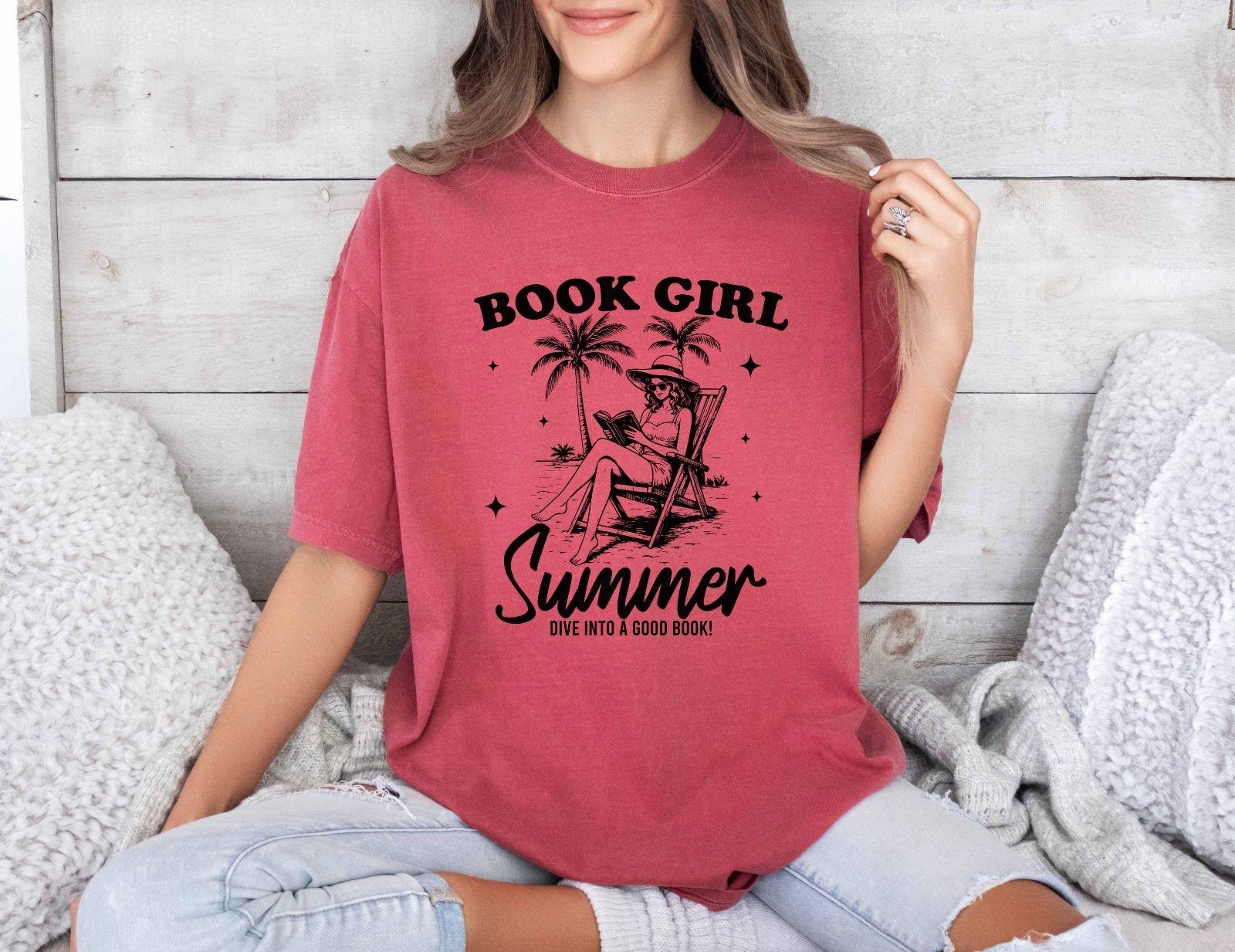 A comfort colors shirt with the saying "book girl summer dive into a good book"