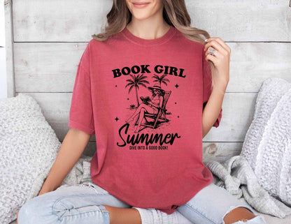 A comfort colors shirt with the saying "book girl summer dive into a good book"