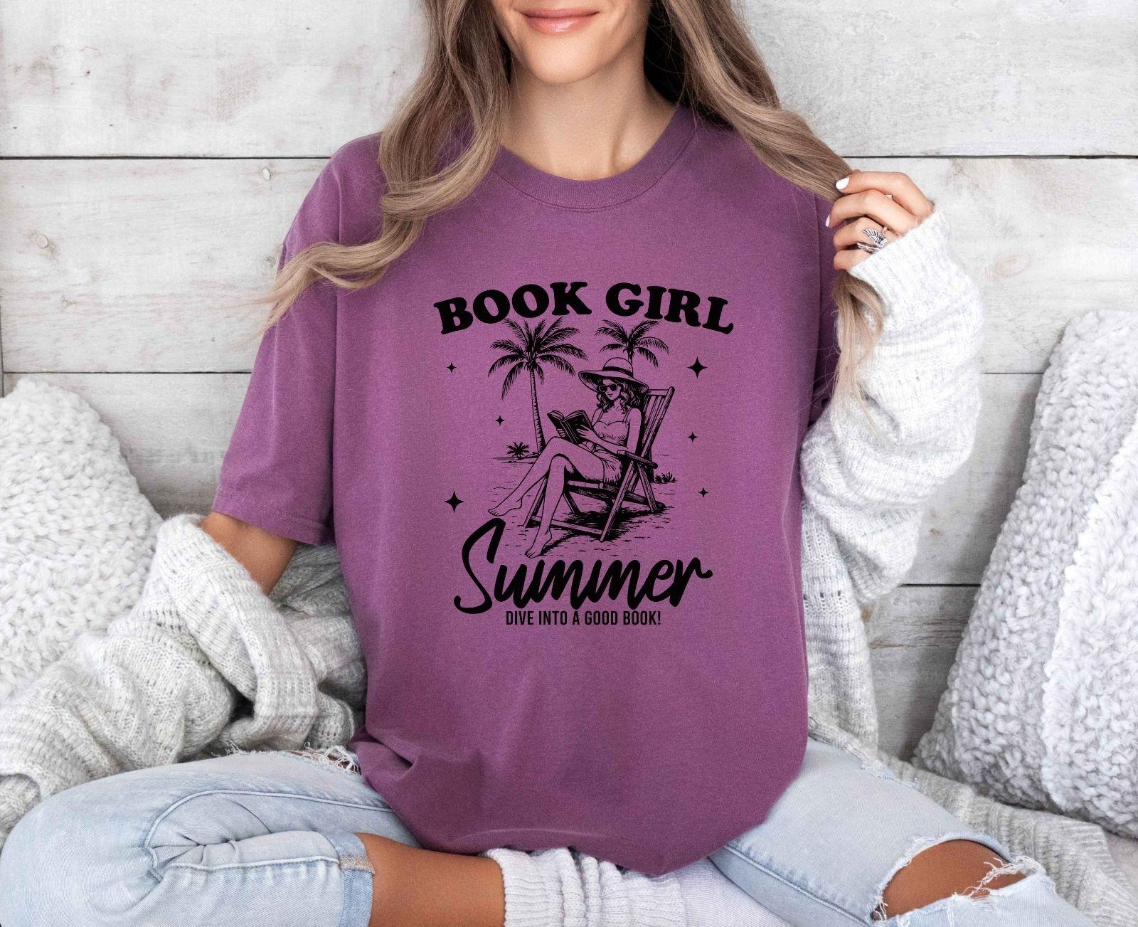 A comfort colors shirt with the saying "book girl summer dive into a good book"