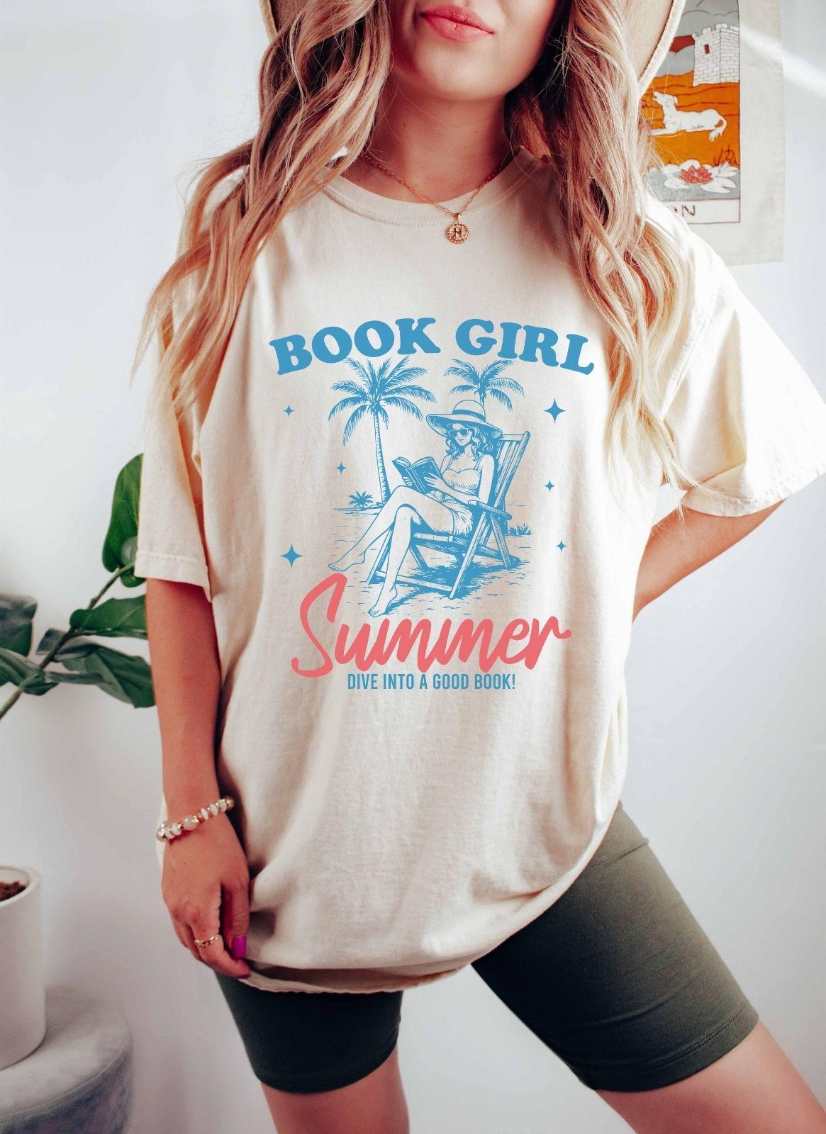 A comfort colors shirt with the saying "book girl summer dive into a good book"