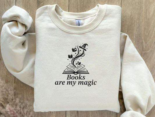A Gildan 18000 sweatshirt with the saying "books are my magic"