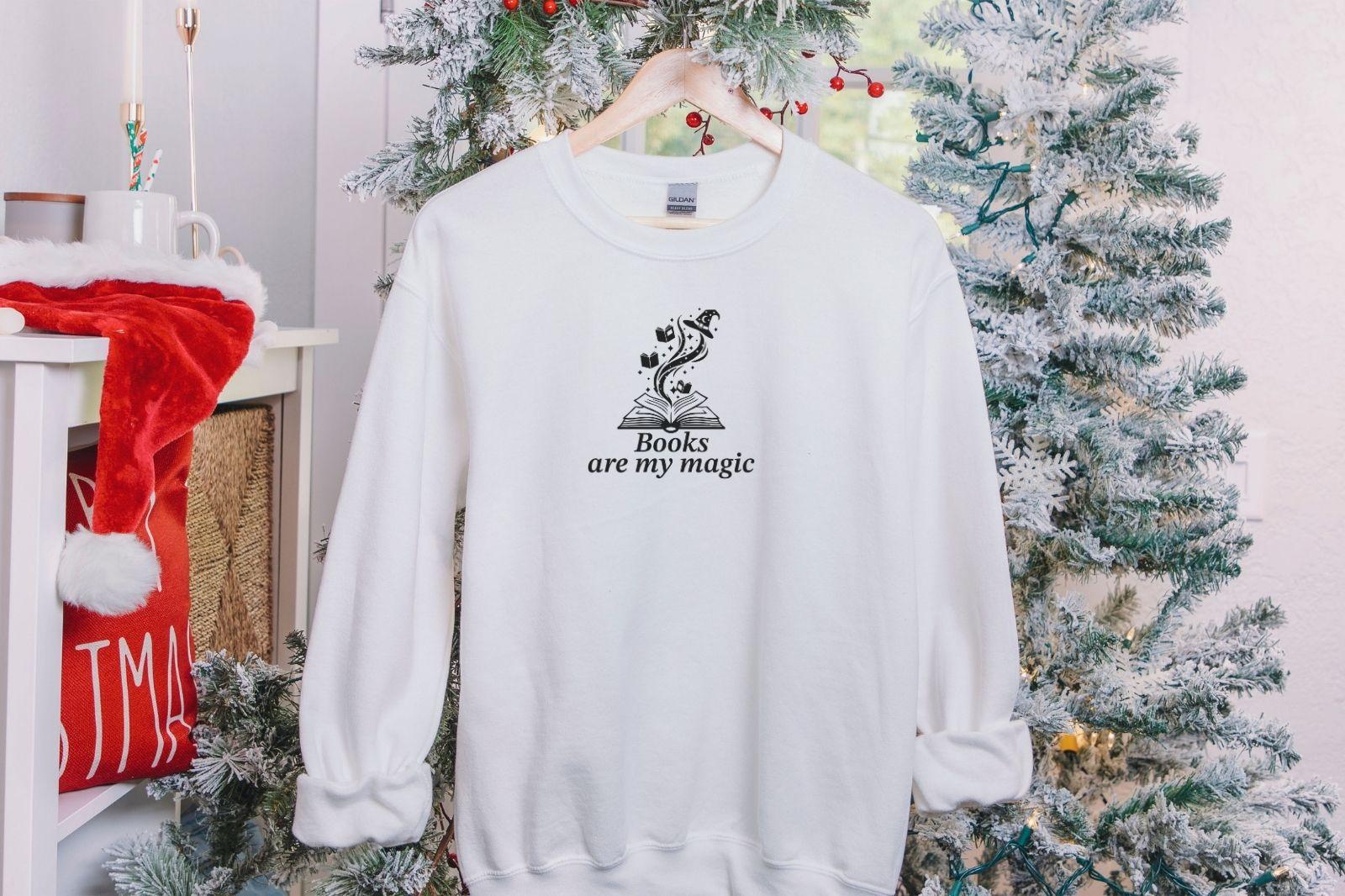 A Gildan 18000 sweatshirt with the saying "books are my magic"