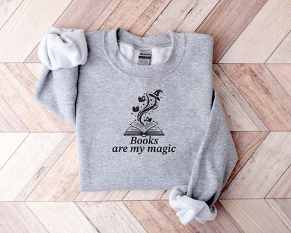 A Gildan 18000 sweatshirt with the saying "books are my magic"