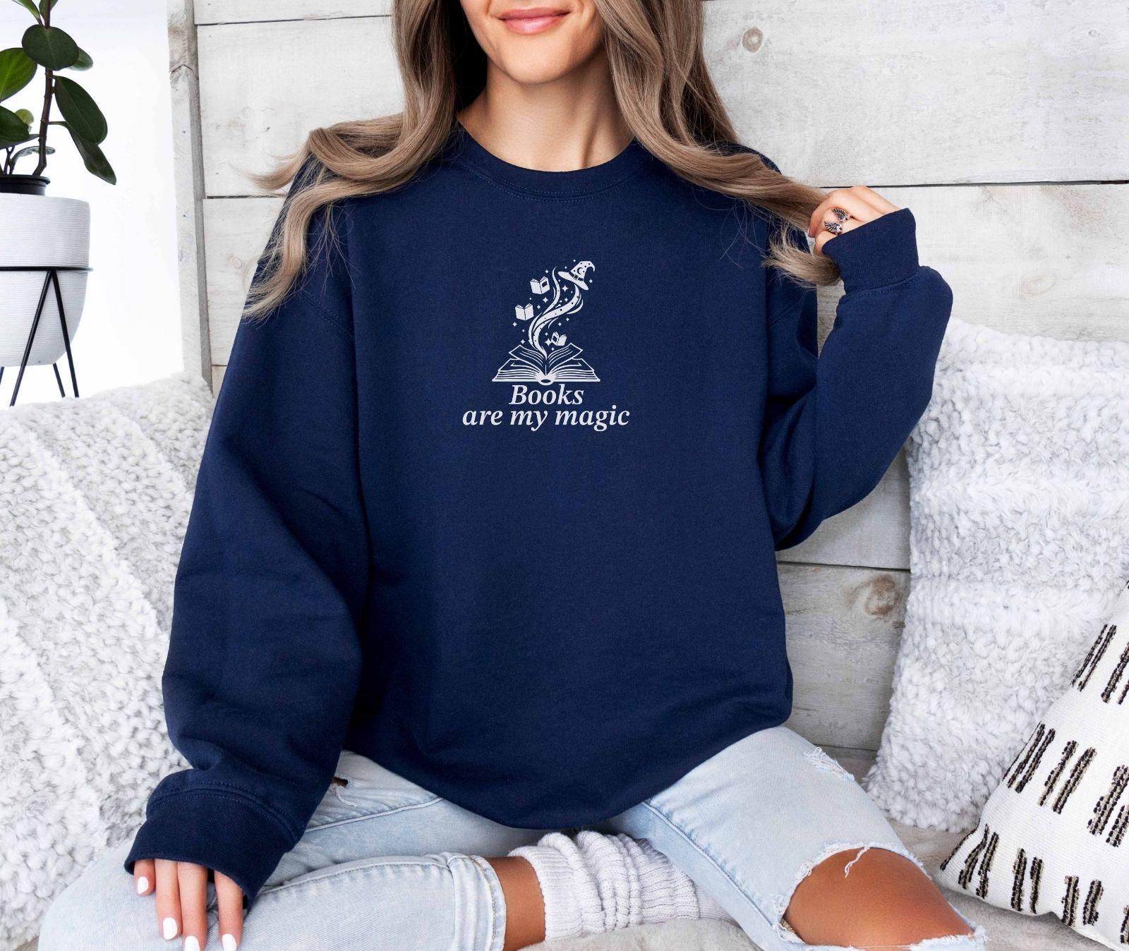 A Gildan 18000 sweatshirt with the saying "books are my magic"