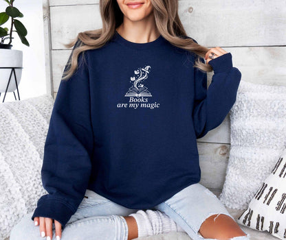 A Gildan 18000 sweatshirt with the saying "books are my magic"