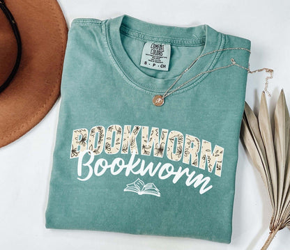 A comfort colors shirt with the saying "Bookworm"