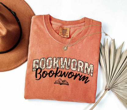 A comfort colors shirt with the saying "Bookworm"