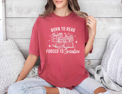A comfort colors shirt with the saying "Born To Read Forced To socialize"