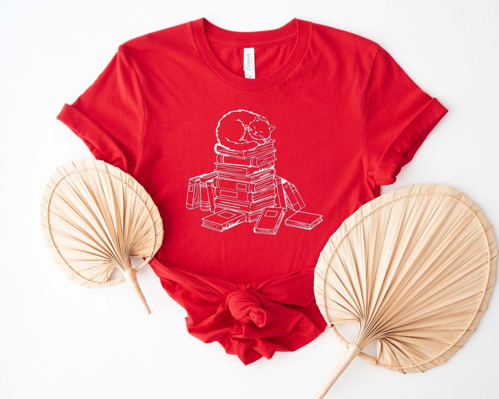 A comfort colors® shirt with the saying "cats and books"