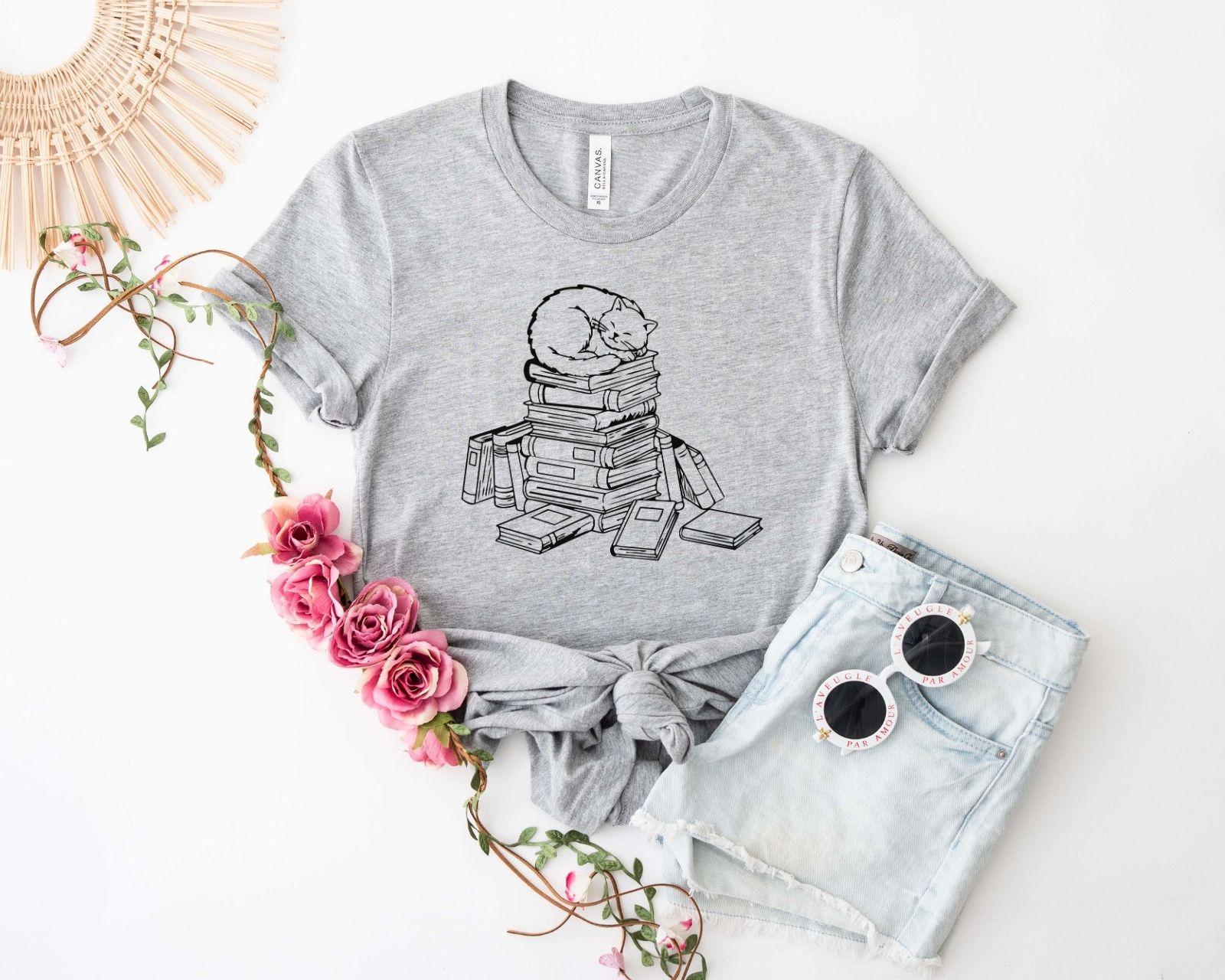 A comfort colors® shirt with the saying "cats and books"