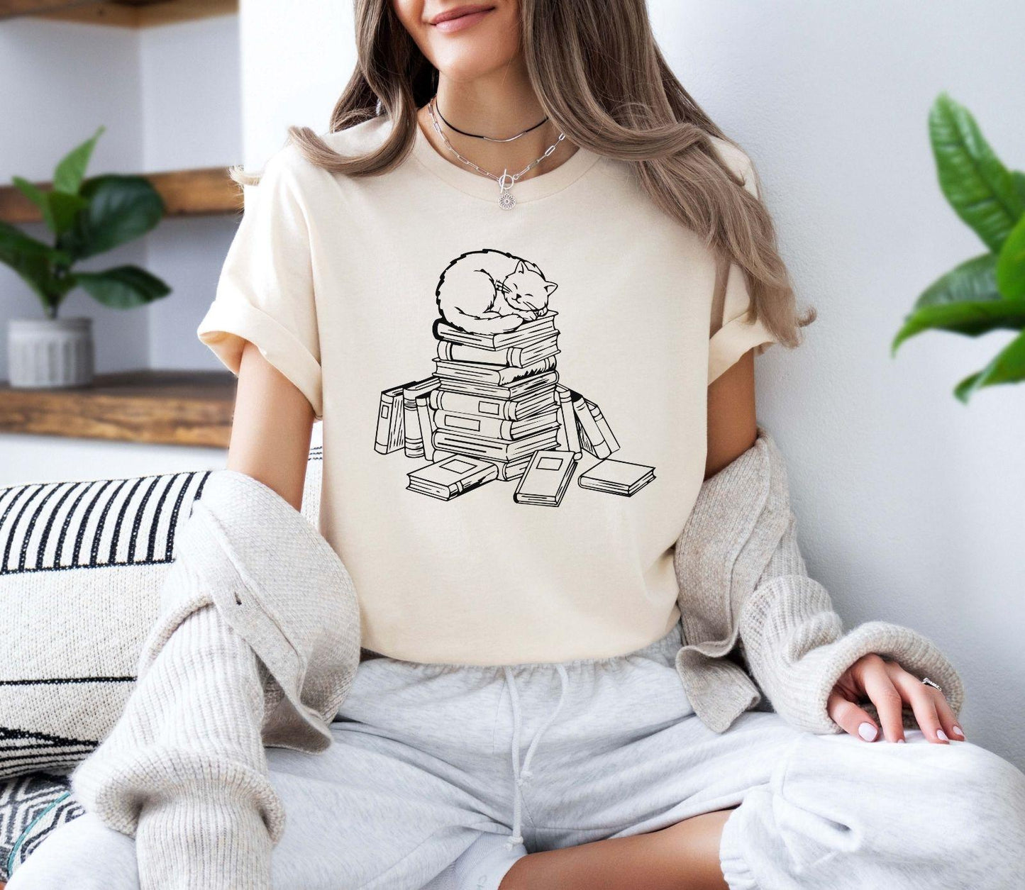A comfort colors® shirt with the saying "cats and books"