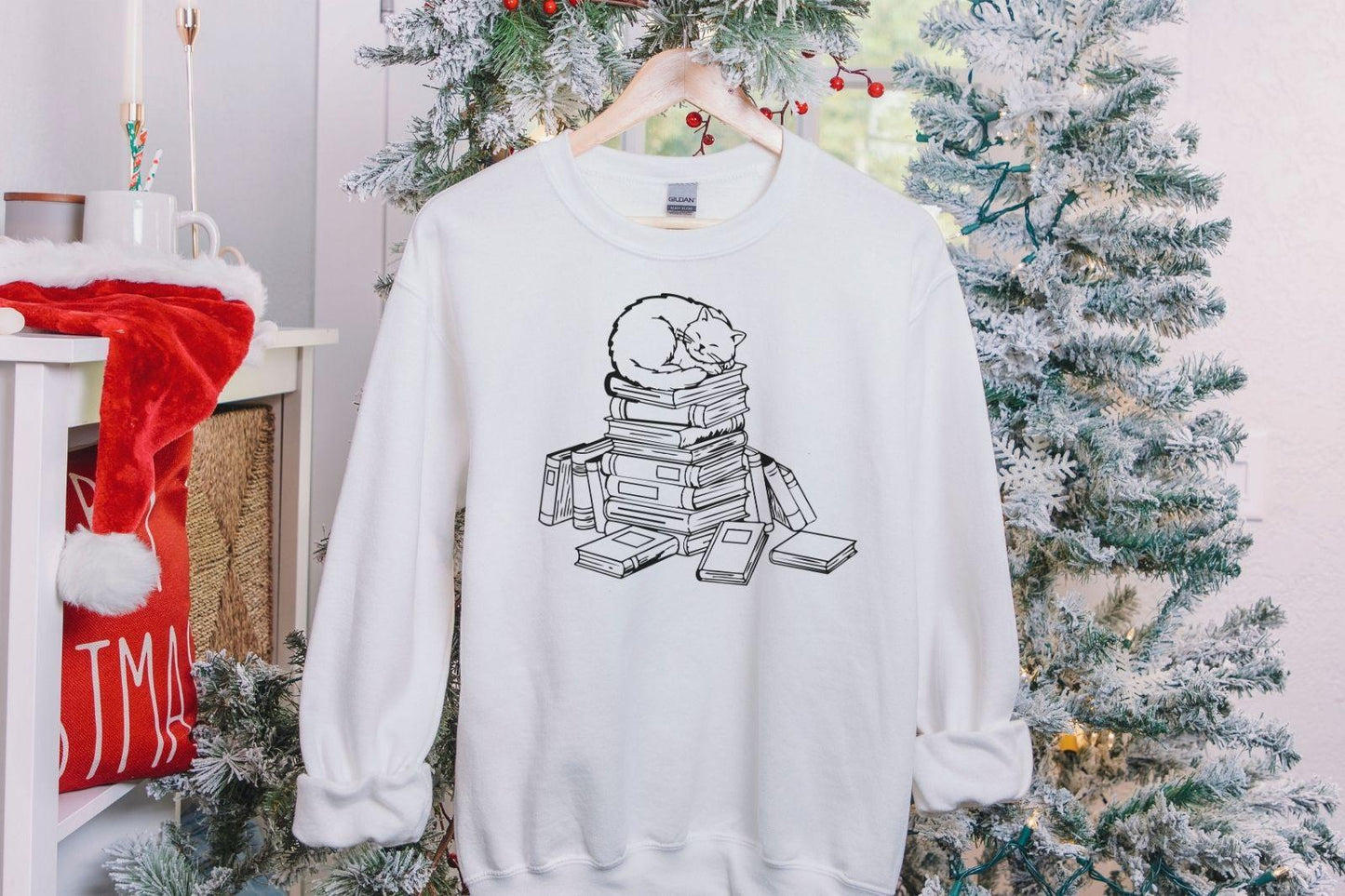 A Gildan 18000 sweatshirt with the saying "a cat with books"
