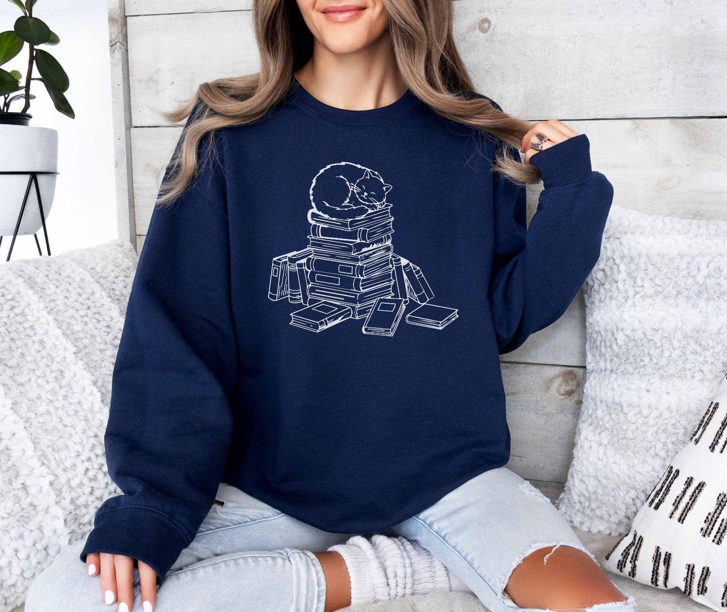 A Gildan 18000 sweatshirt with the saying "a cat with books"