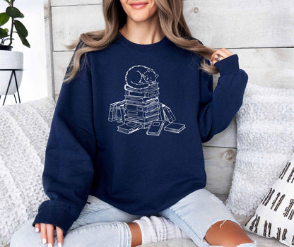 A Gildan 18000 sweatshirt with the saying "a cat with books"