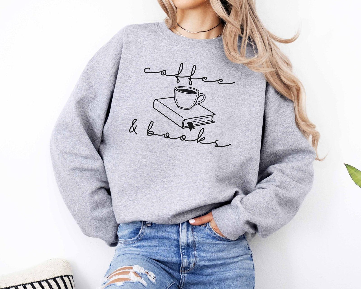 A Gildan 18000 sweatshirt with the saying "coffee and books"