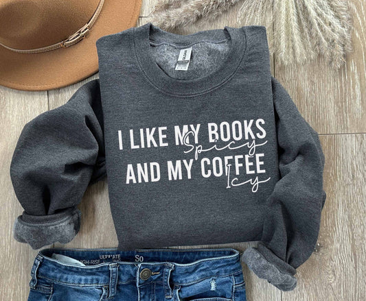 A dark heather color sweatshirt with the saying "I like my books spicy and my coffee icy"