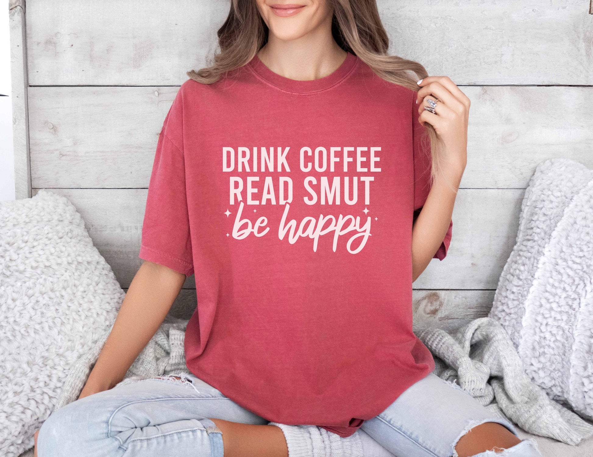 A comfort colors shirt with the saying "Drink coffee read books be happy"