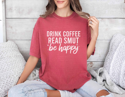 A comfort colors shirt with the saying "Drink coffee read books be happy"