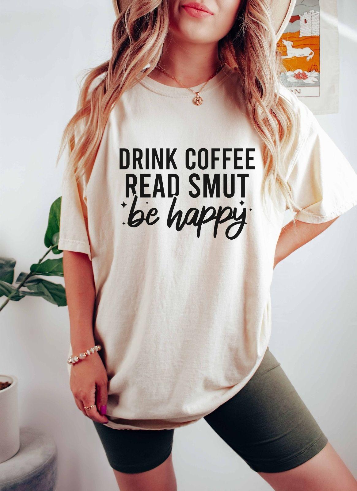 A comfort colors shirt with the saying "Drink coffee read books be happy"