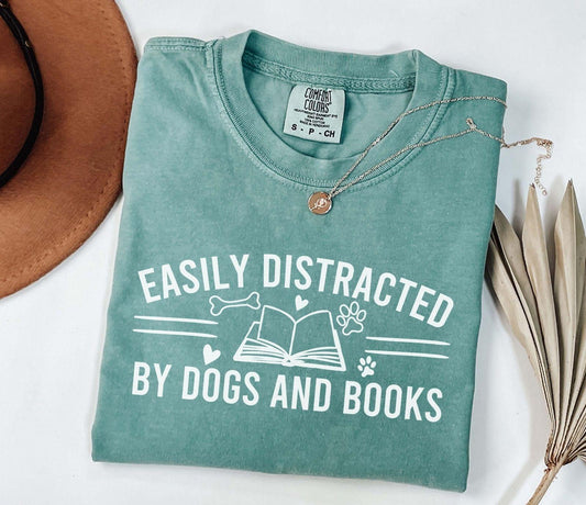 A comfort colors® shirt with the saying "Easily distracted by dogs and books"