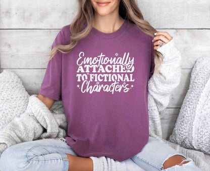 A comfort colors® shirt with the saying "Emotionally attached to fictional characters"