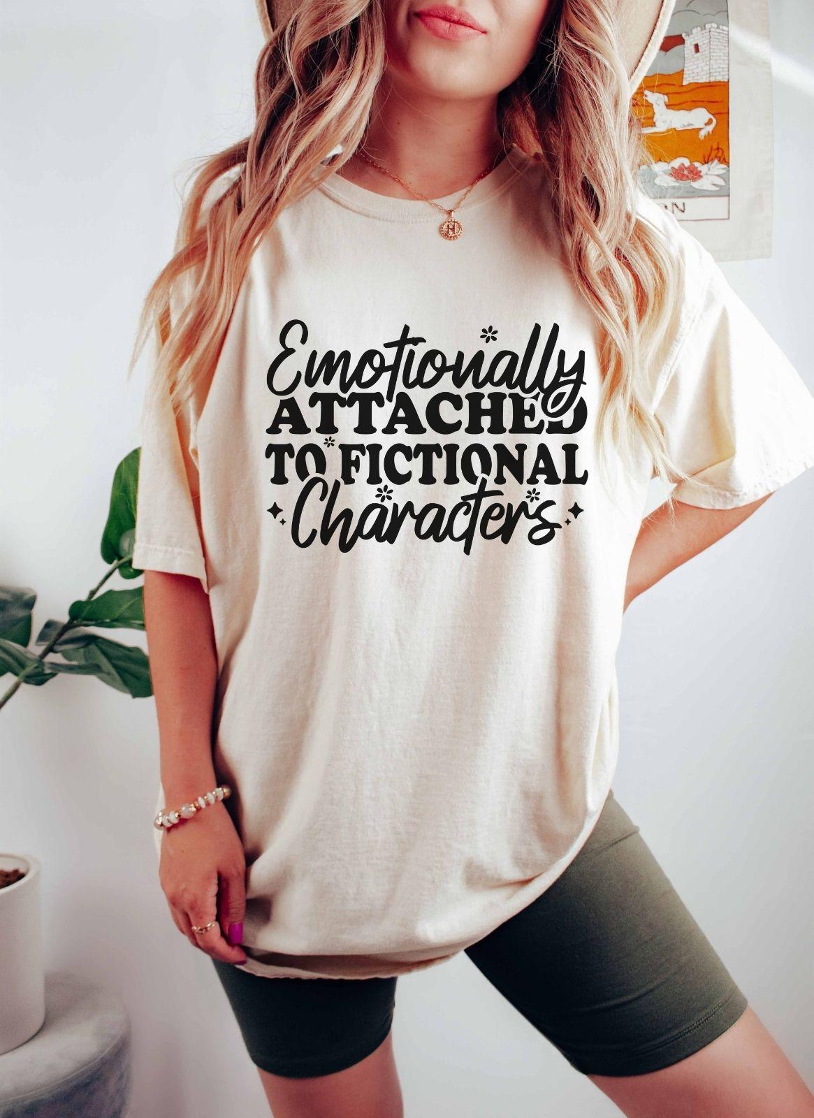 A comfort colors® shirt with the saying "Emotionally attached to fictional characters"