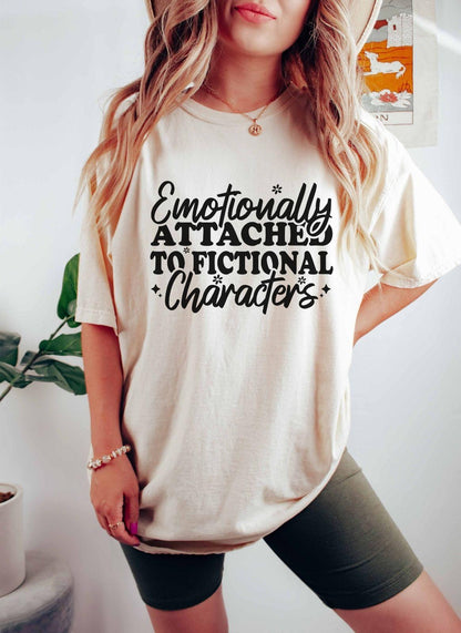 A comfort colors® shirt with the saying "Emotionally attached to fictional characters"