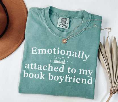 A comfort colors® shirt with the saying "Emotionally attached to my book boyfriend"