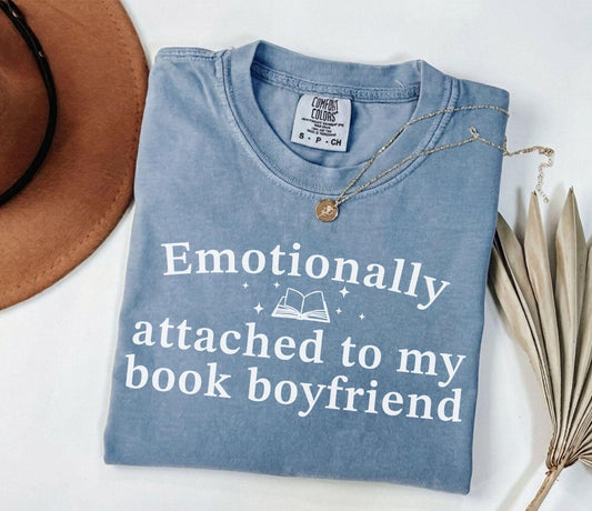 A comfort colors® shirt with the saying "Emotionally attached to my book boyfriend"