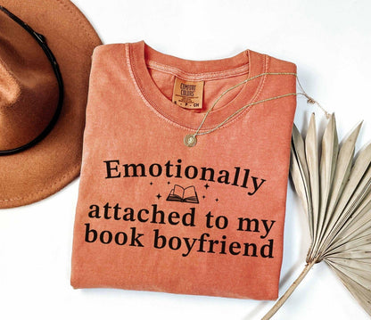 A comfort colors® shirt with the saying "Emotionally attached to my book boyfriend"