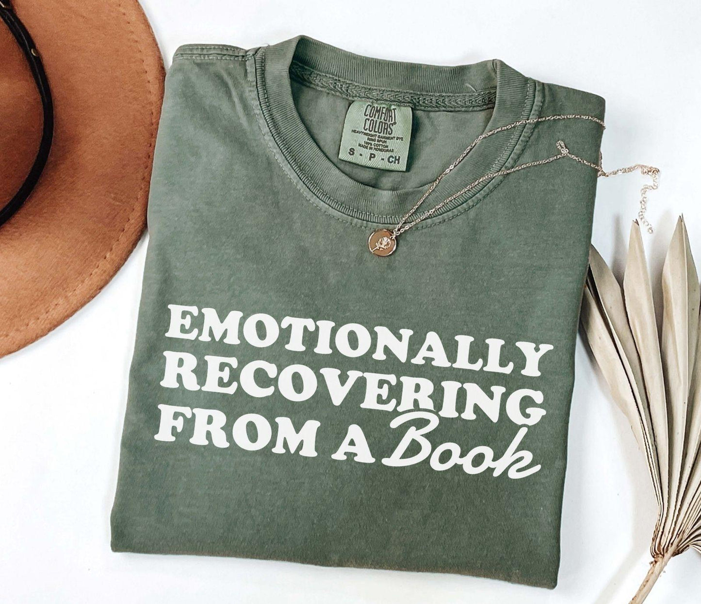 A comfort colors® 1717 shirt with the saying "Emotionally recovering from a book"