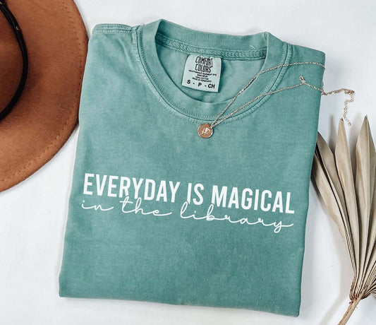 A comfort colors® shirt with the saying "everyday is magical in the library"