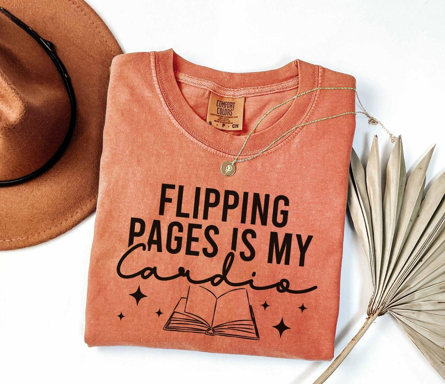 A comfort colors shirt with the saying "Flipping pages is my cardio"