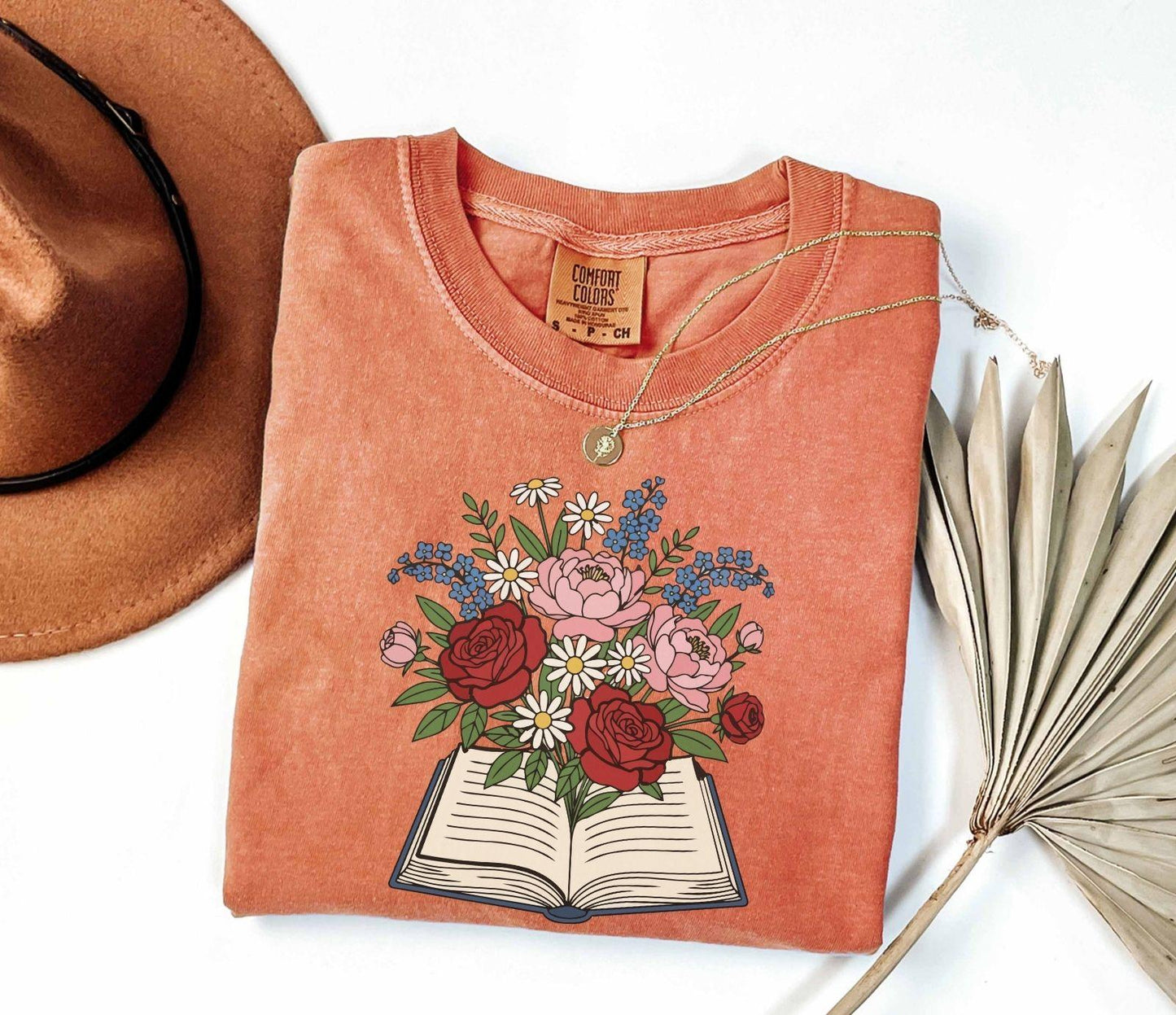 A comfort colors® shirt with the saying "flowered book"