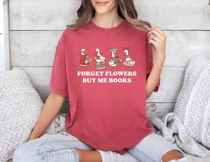 A comfort colors shirt with the saying "Forget flowers buy me books"