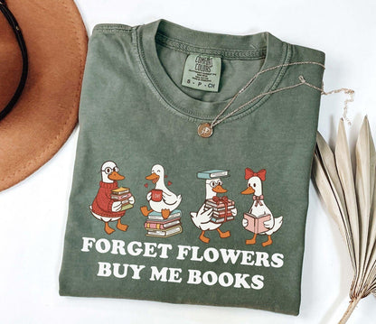 A comfort colors shirt with the saying "Forget flowers buy me books"