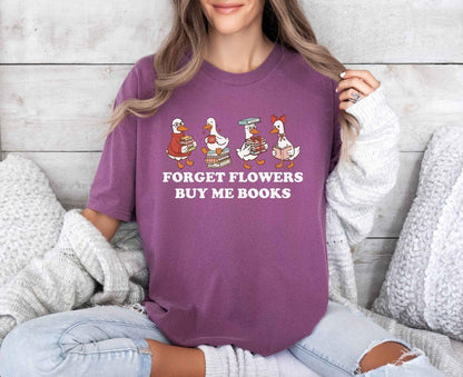 A comfort colors shirt with the saying "Forget flowers buy me books"