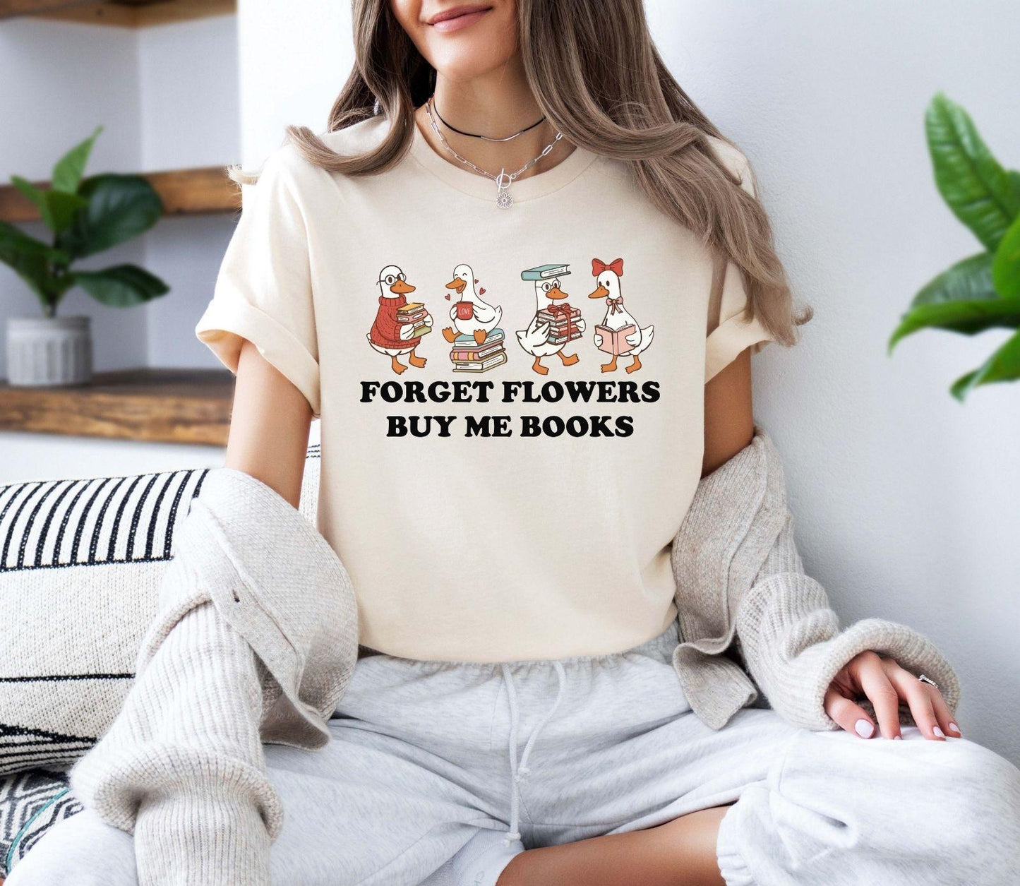 A gildan 18000 sweatshirt with the saying "Forget flowers buy me books"