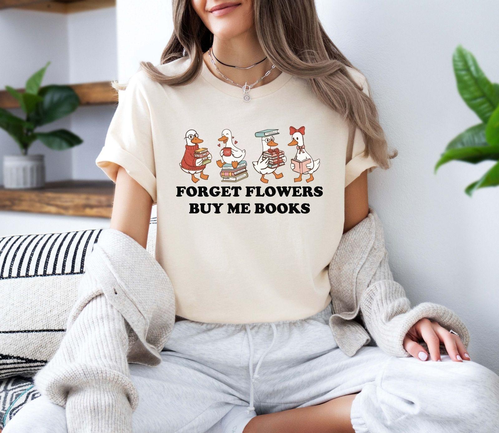A gildan 18000 sweatshirt with the saying "Forget flowers buy me books"