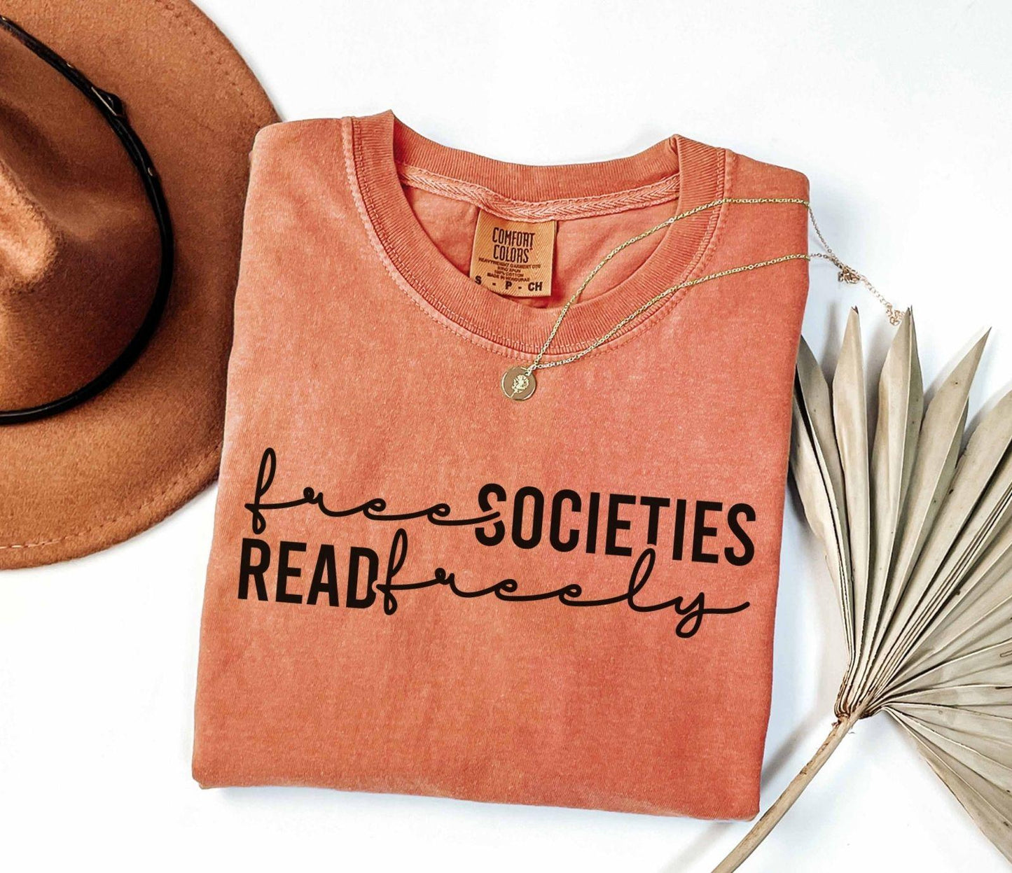 A comfort colors shirt with the saying "Free societies read freely"